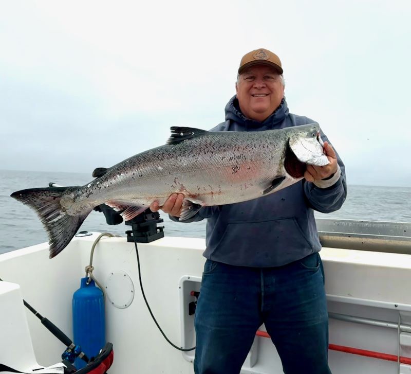 Man holding large salmon.
